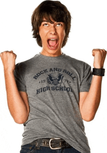 a young man wearing a grey rock and roll high school shirt