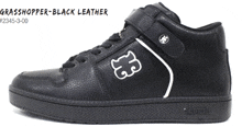 a pair of black leather shoes with a white g on the side