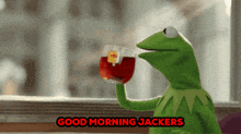 kermit the frog drinking a cup of tea with the words " good morning jackers " behind him
