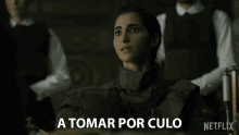 a woman in a military uniform says " a tomar por culo " in spanish