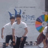 a group of people are dancing in front of a sign that says event