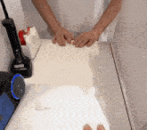 a person 's hands are on a white table next to a tape dispenser that says ' tape ' on it