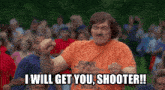a man wearing an orange shirt that says " guns men kill people "