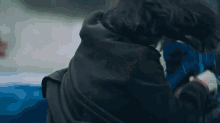 a man and a woman are fighting in a car .