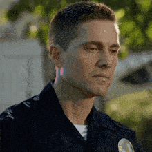 a close up of a police officer 's face with a badge that says ' los angeles ' on it