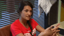 a woman in a red shirt that says the challenge on it