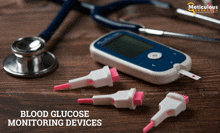 a blood glucose monitoring device is sitting on a wooden table next to a stethoscope