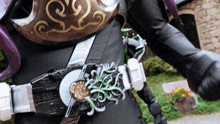 a person wearing a costume with a belt that has a green swirl on it