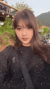 a woman wearing a black shirt with a star on it and a black strap with the number 08 on it