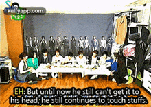 a group of people are sitting around a table in a room with a caption .