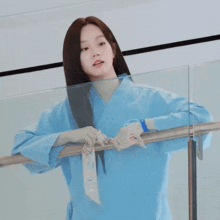 a woman wearing a blue shirt with the word gucci on the front