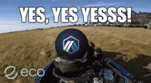 a man in a helmet says yes yes yesss on a sandy beach
