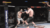 two men are fighting in a ufc cage with a metropcs banner behind them