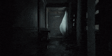 a dark hallway with a white curtain hanging from the window