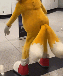 a fox mascot is standing on a tiled floor