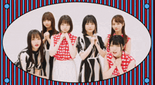 a group of young girls are posing for a picture in a striped frame