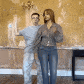 a man and a woman are dancing in a room with a yellow wall .