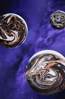 three marbled planets are floating in space