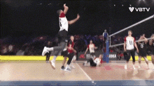 a volleyball game is being broadcasted on vbtv and a player jumps in the air