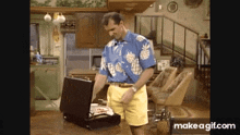 a man in a pineapple shirt is opening a briefcase ..