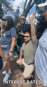 a group of people are standing in a line with interest rates written on the bottom of the image