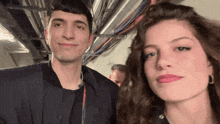 a man and a woman are posing for a photo