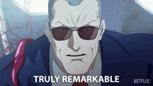 a picture of a man with glasses and the caption truly remarkable