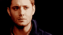 a close up of a man 's face with a tear coming out of his eye .