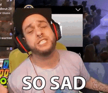 a man wearing headphones is making a sad face