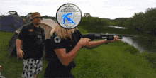 a woman is holding a shotgun in front of a sign that says sniper on it