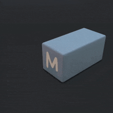a cube with the letter m on it