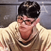 a man wearing glasses is surrounded by math equations on a chalkboard