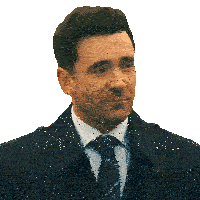 a man in a suit and tie is looking at the camera