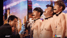 a group of men are lined up with their tongues out and a nbc logo on the bottom