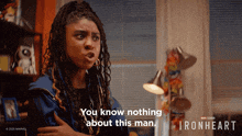 a woman says " you know nothing about this man " in front of a sign that says ironheart