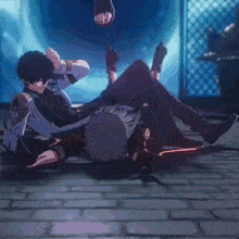 a man is laying on the ground while a woman is standing next to him