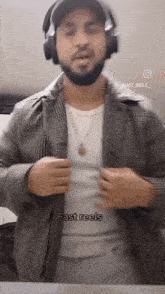a man wearing headphones and a jacket with the words fast reels on the bottom
