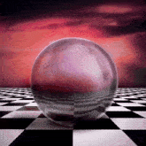 a glass ball sits on a checkered floor with a red sky in the background