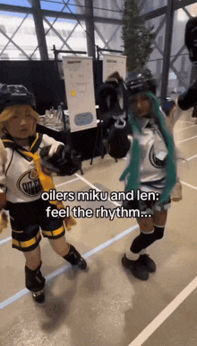 two people dressed as oilers miku and len are dancing together