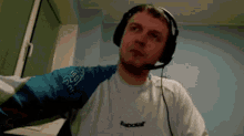 a man wearing headphones and a shirt that says babolat