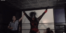 a female wrestler is being congratulated by a referee in a ring that says arto