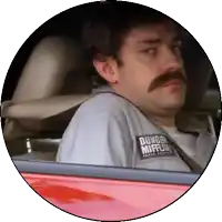 a man with a mustache wears a shirt that says dundee mifflin