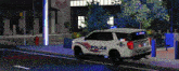 a white police suv is parked on the side of the road