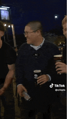 a man is holding a glass of beer with the word want on it