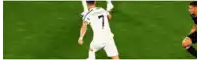 a soccer player with the number 7 on his jersey is dribbling the ball