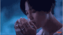 a close up of a person eating a sandwich with their hands .