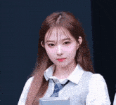 a young woman wearing a white shirt and tie