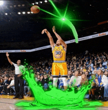 a basketball player in a yellow jersey with the number 30 on it