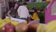 a girl in a yellow sweater is sitting in front of a group of children