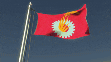 a red flag with a white gear and a yellow hand on it